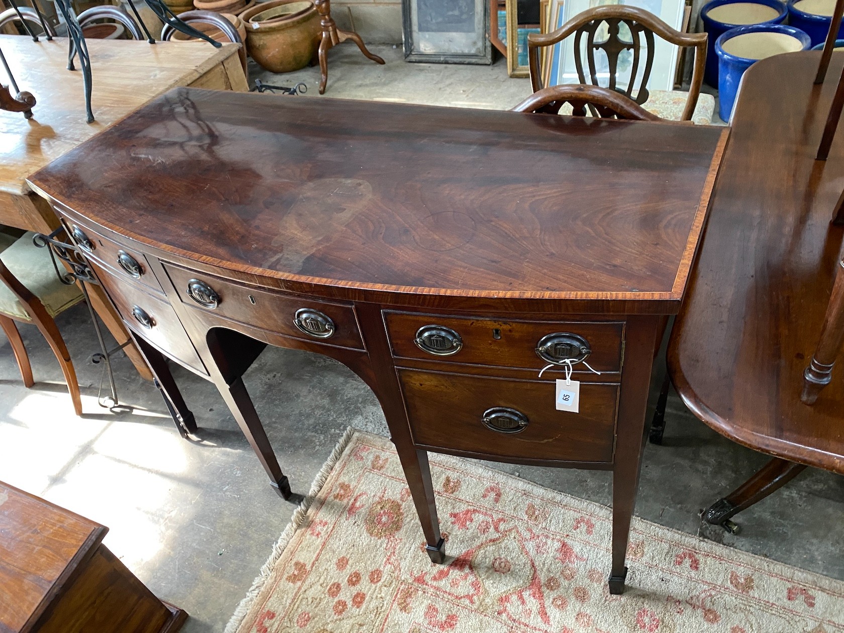 A George III satinwood banded mahogany bow front sideboard, length 138cm, depth 62cm, height 89cm